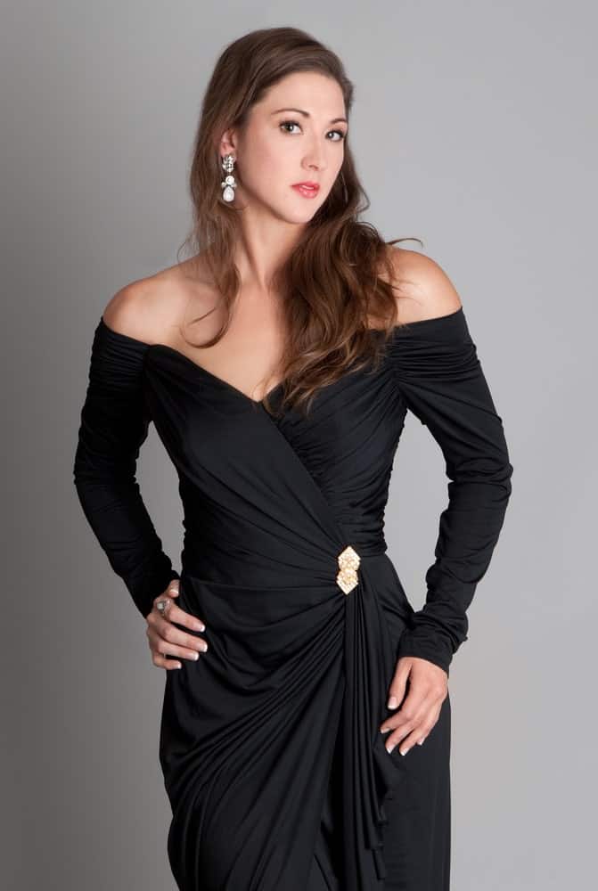 This is a close look at a woman wearing an elegant off shoulder dress.