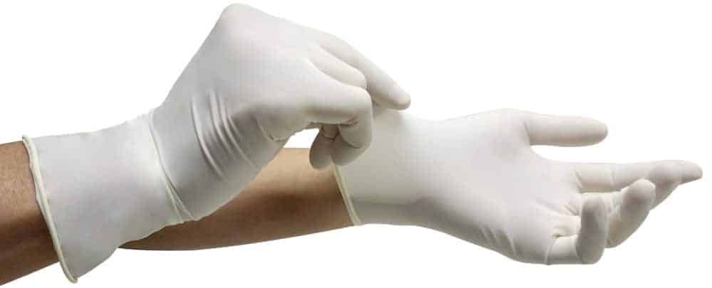 A pair of hands putting on latex gloves.
