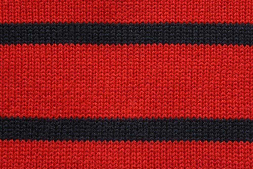 This is a close look at a red and black knitted fabric.