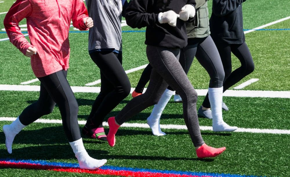 A close look at a group of women wearing spandex leggings.