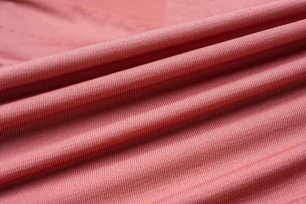 This is a close look at a piece of pink Knit Fabric.