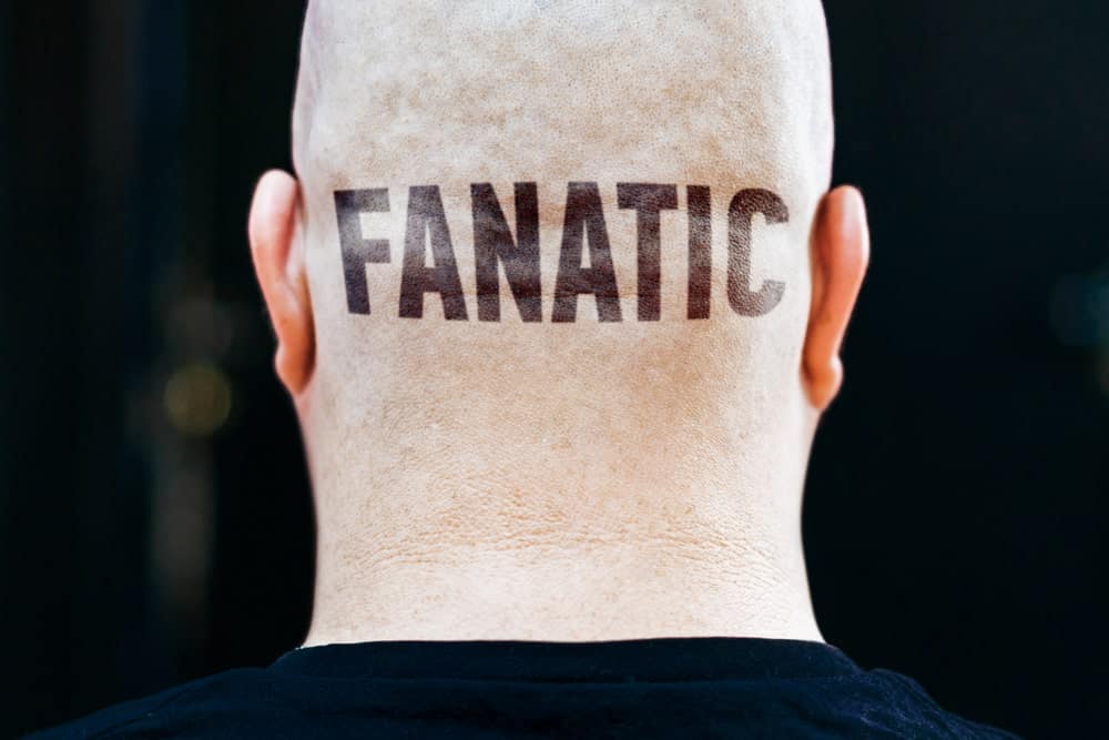 This is a close look at the back of a man's head with the word FANATIC tattooed on it.
