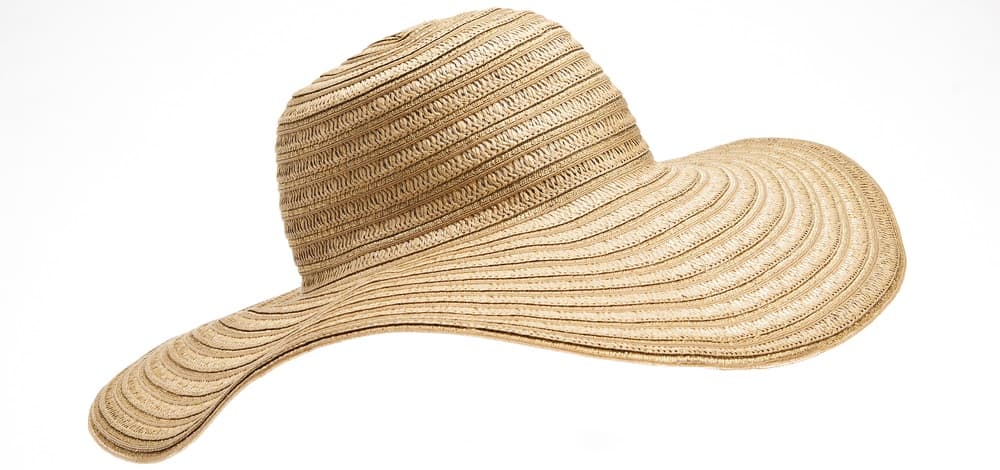 This is a close look at a woman's wide brim straw beach hat.