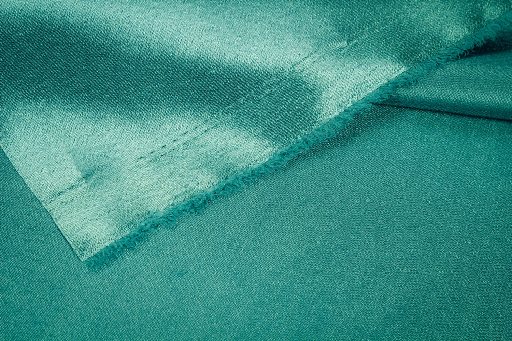 This is a close look at a green Crepe fabric.