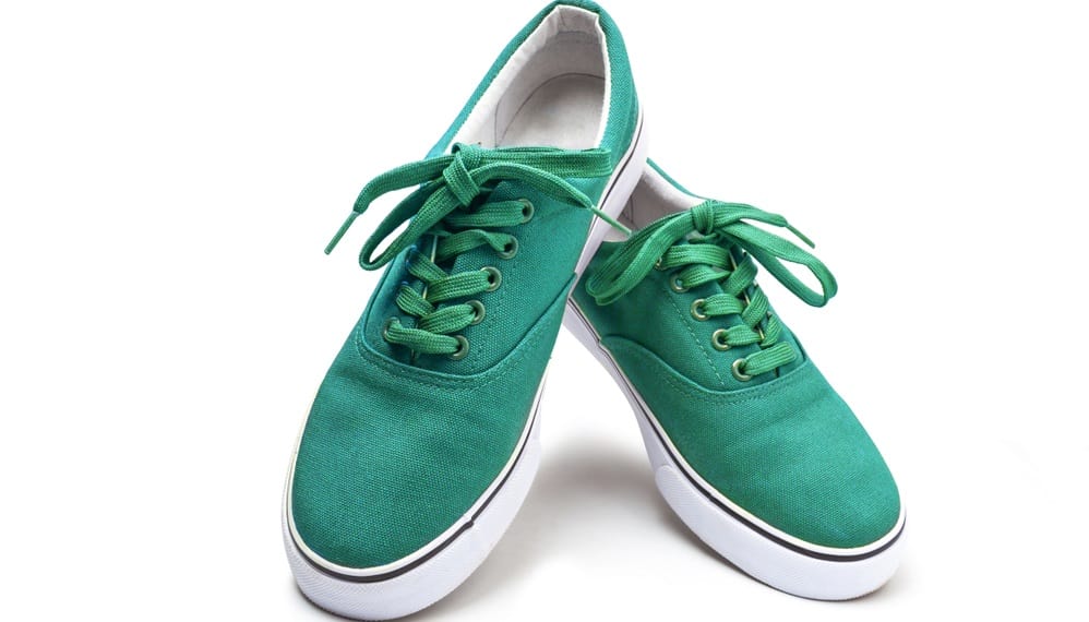 This is a pair of green sneakers made of Canvas.