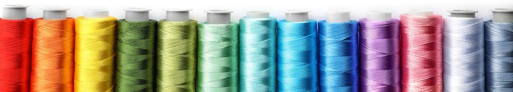 This is a close look at various colorful sewing threads.