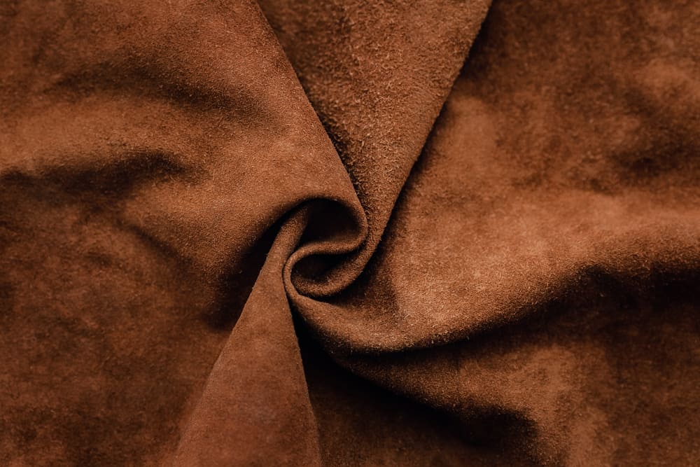 This is a close look at a piece of genuine brown suede fabric.