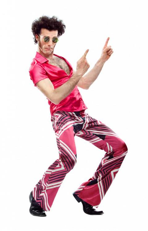 Man in a disco outfit with pink shirt and matching wide pants.