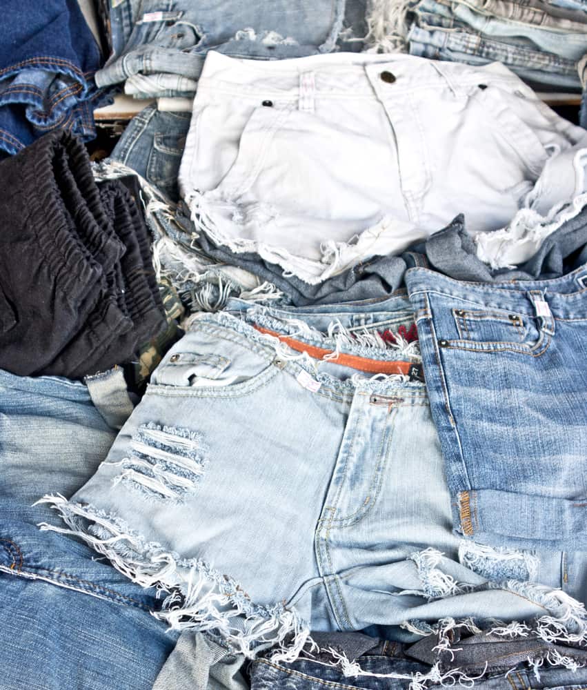 This is a close look at a bunch of frayed and distressed jean shorts.