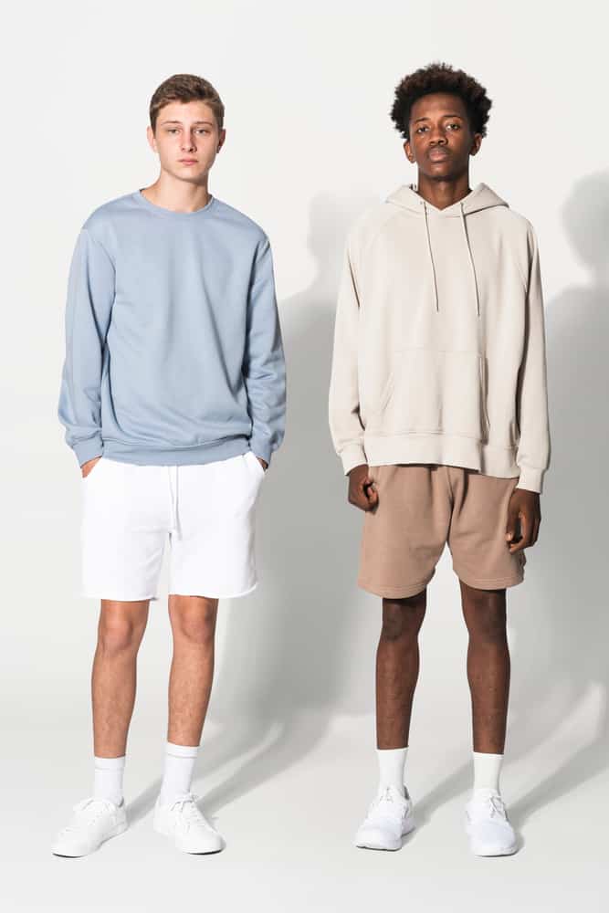 Two teen guys wearing shorts and socks with their outfits.