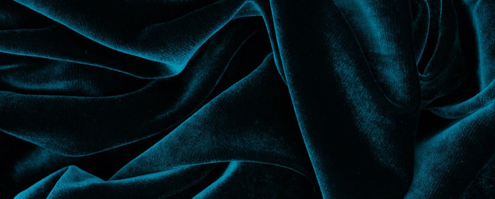 This is a close look at a dark green velvet fabric.