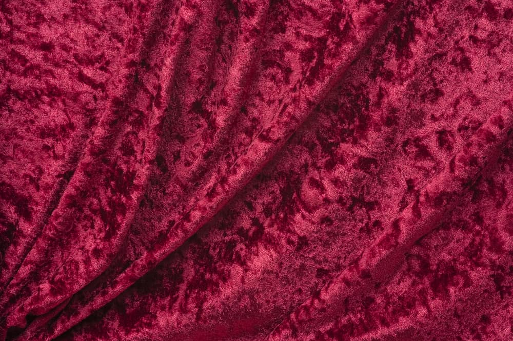 This is a close look at a crimson crushed velvet fabric.