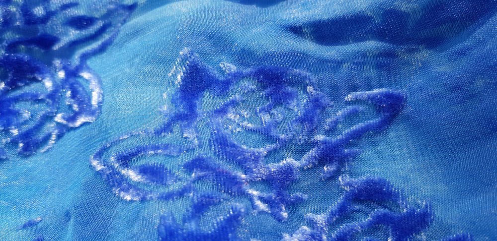 This is a close look at a blue embossed velvet fabric.
