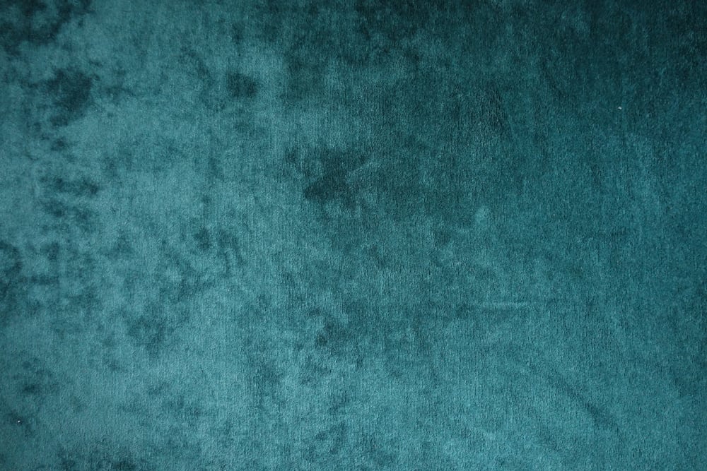 This is a close look at a dark green plain velvet fabric.