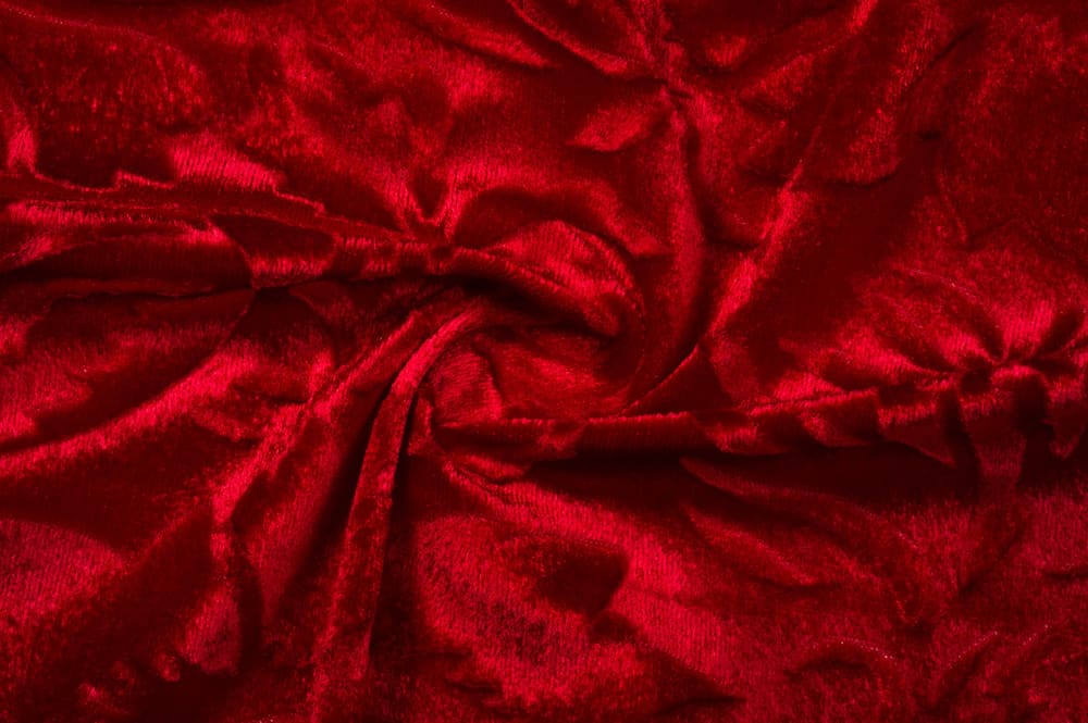 This is a close look at a dark red stretch velvet fabric.