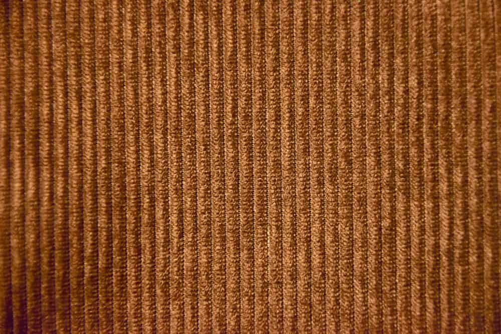 This is a dark brown corduroy velvet fabric.