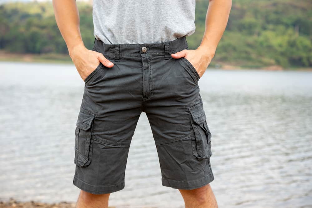 This is a close look at a man wearing a pair of cargo Bermuda shorts.
