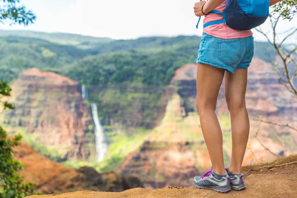 This is a close look at a woman wearing shorts on a hike.