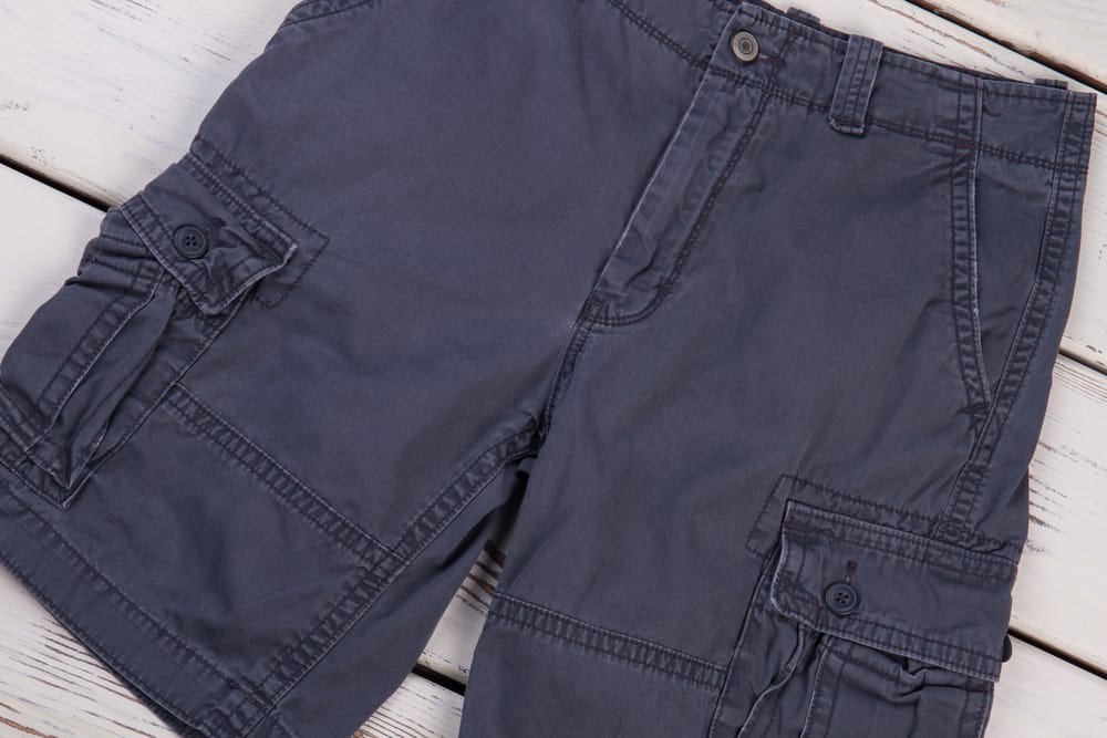 This is a close look at a pair of dark gray men's cargo shorts.