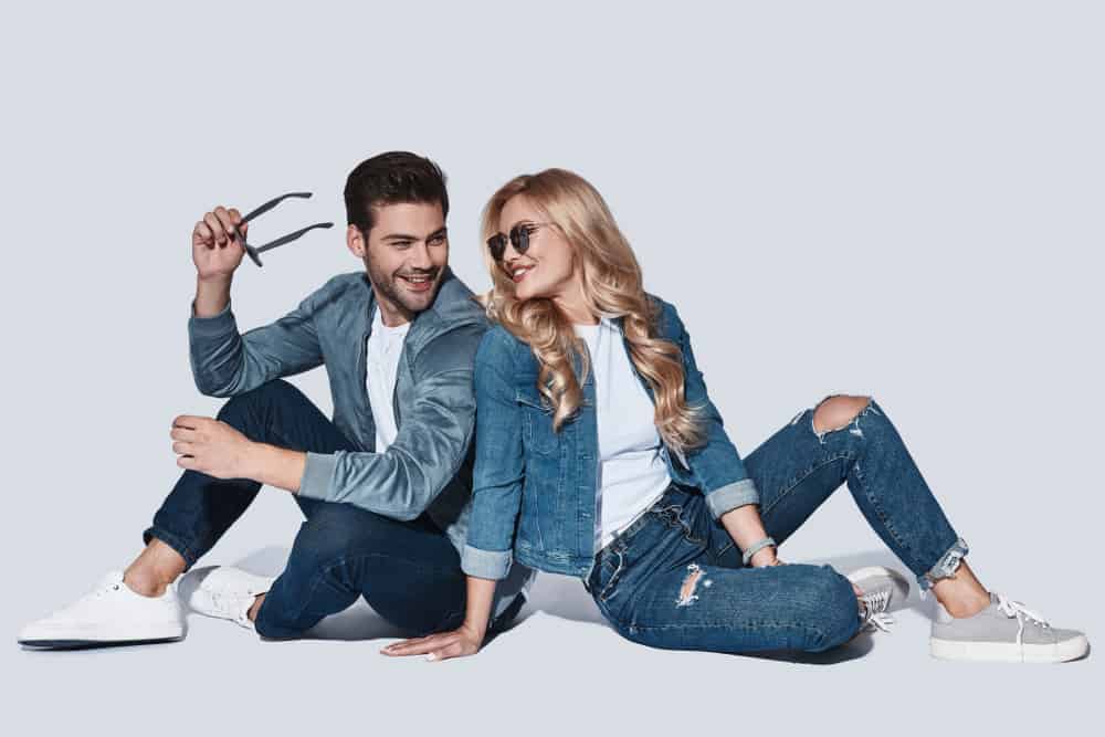 A man and a woman both wearing jeans and jackets.