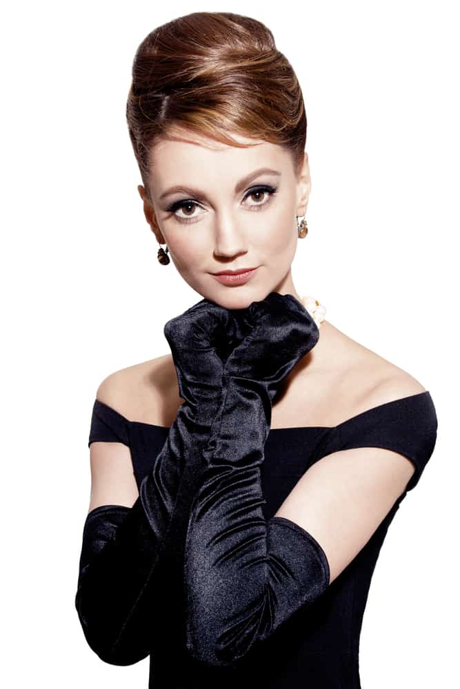 This is a woman wearing a black dress with black gloves.