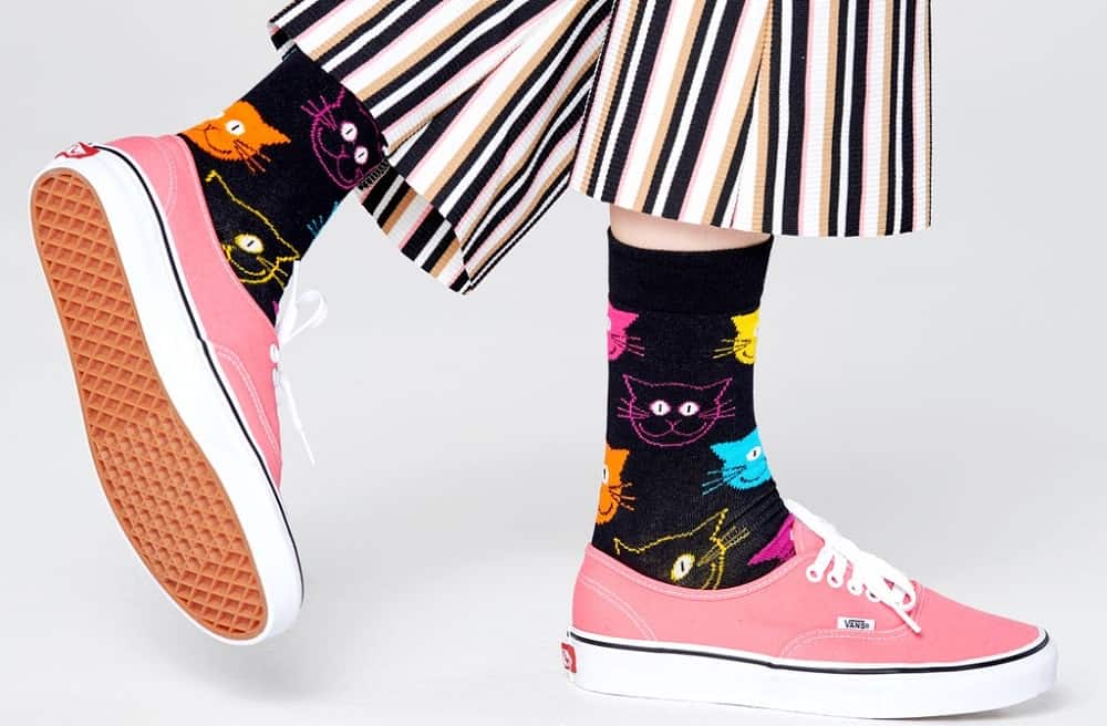 A pair of black cat socks with colorful patterns from Happy Socks.