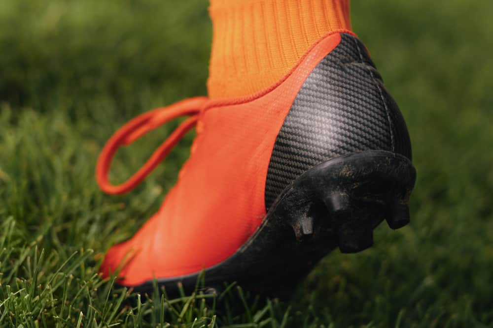 A close look at a football player wearing cleats.
