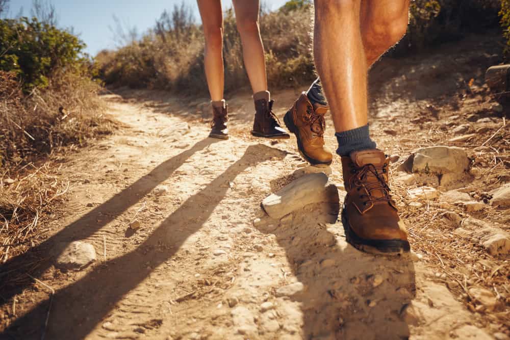 A close look at a couple of hikers wearing hiking shoes.