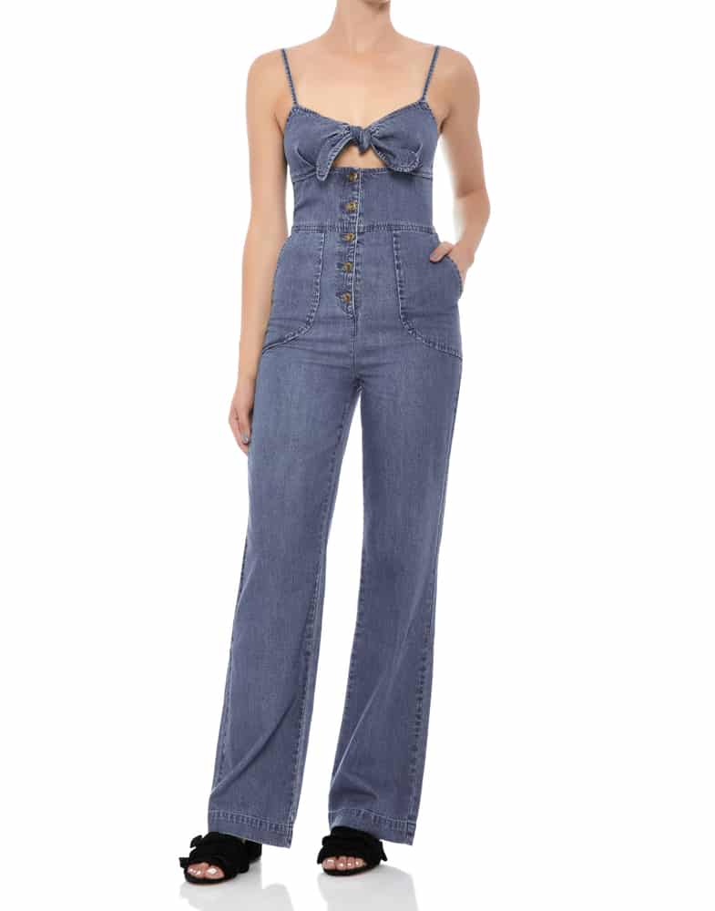 A close look at a woman wearing a one-piece denim jumpsuit.