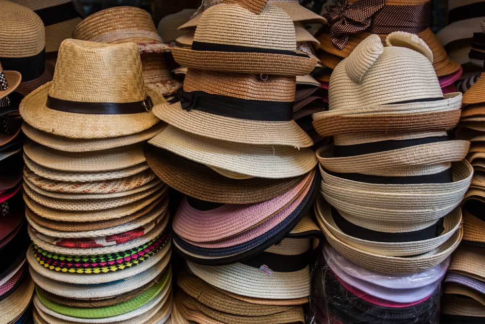 This is a close look at stacks of fedoras for sale.