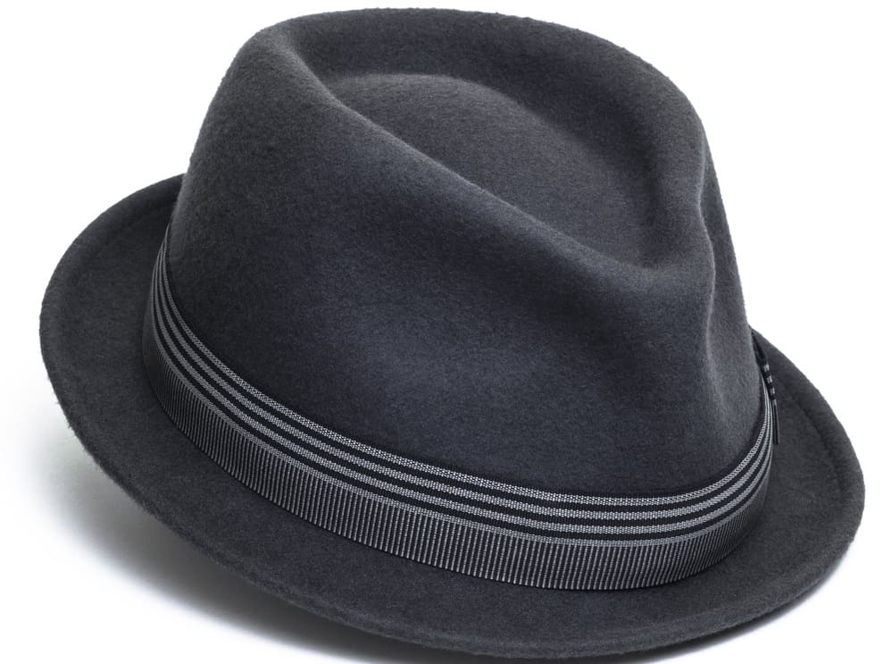 This is a close look at a dark gray trilby hat with a striped band.