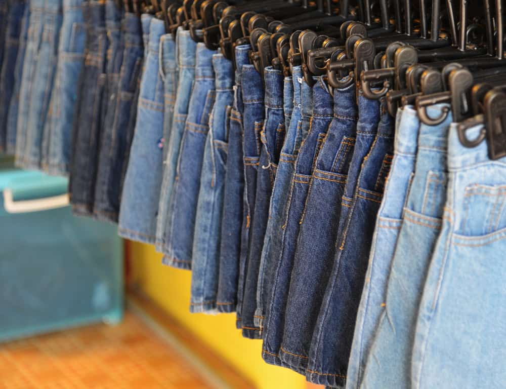 This is a row of various denim skirts on display at a shop.